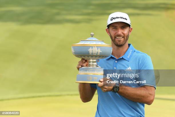Dustin Johnson poses with the trophy after winning the World Golf Championships-Dell Technologies Match Play at the Austin Country Club on March 26,...