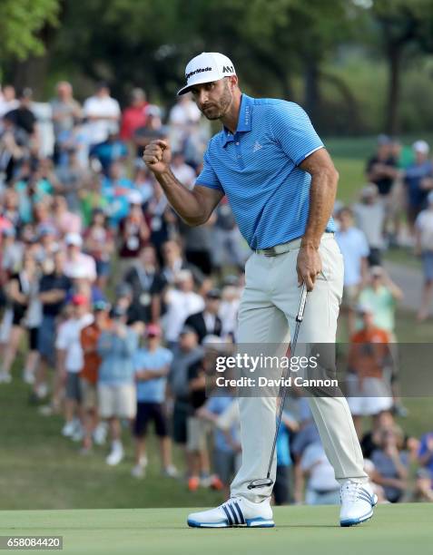 Dustin Johnson of the United States celebrates holing the winning putt on the 18th green to win by 1 up in his match against John Rahm of Spain...