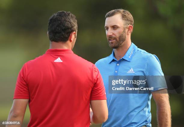 Dustin Johnson shakes hands with Jon Rahm of Spain after winning the final match of the World Golf Championships-Dell Technologies Match Play 1 up on...