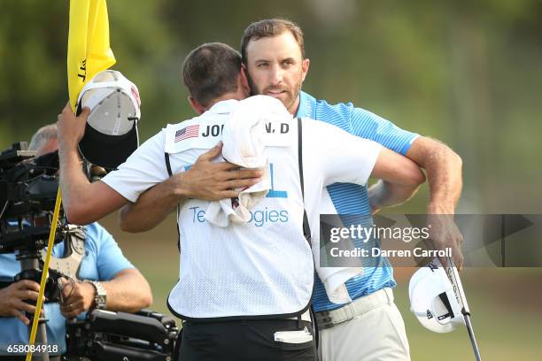 Dustin Johnson celebrates with his caddie Austin Johnson after winning the final match of the World Golf Championships-Dell Technologies Match Play...