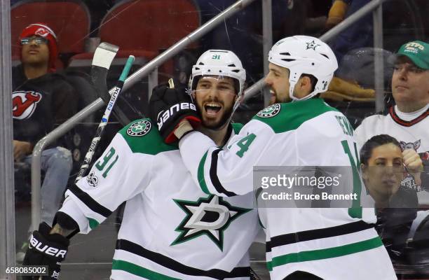 Tyler Seguin of the Dallas Stars scores at 20 seconds of overtime against the New Jersey Devils and is joined by Jamie Benn at the Prudential Center...