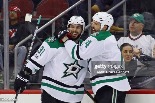 Tyler Seguin of the Dallas Stars scores at 20 seconds of overtime against the New Jersey Devils and is joined by Jamie Benn at the Prudential Center...