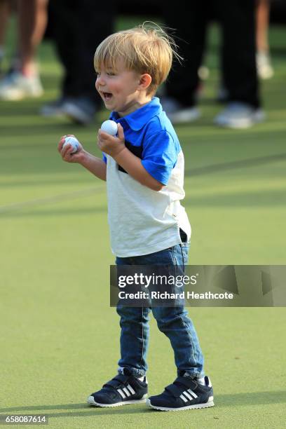 Tatum, son of Dustin Johnson ,, plays with golf balls after the World Golf Championships-Dell Technologies Match Play at the Austin Country Club on...