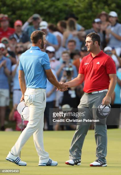 Dustin Johnson shakes hands with Jon Rahm of Spain after winning the World Golf Championships-Dell Technologies Match Play at the Austin Country Club...