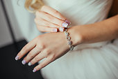 Wedding. Wedding day. Luxury bracelet on the bride's hand close-up Hands of the bride before wedding. Wedding accessories. Selective focus.