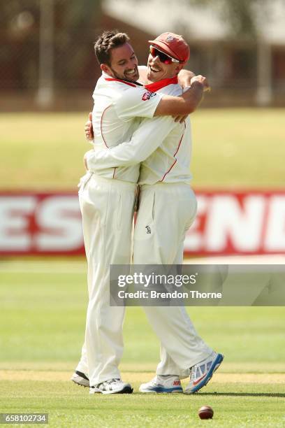 Chadd Sayers of the Redbacks celebrates with team mate Jake Lehmann of the Redbacks after claiming the wicket of Cameron White of the Bushrangers...