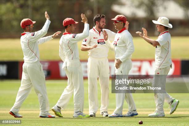 Chadd Sayers of the Redbacks celebrates with team mates after claiming the wicket of Cameron White of the Bushrangers during the Sheffield Shield...