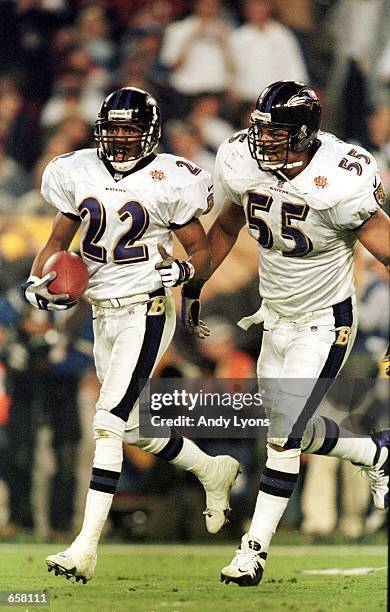 Duane Starks of the Baltimore Ravens runs an interception in for a touch down as teammate Jamie Sharper runs along side in the second half during...