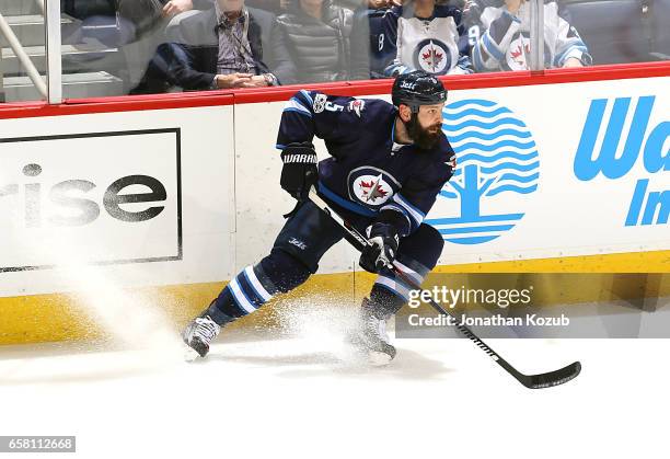 Mark Stuart of the Winnipeg Jets keeps an eye on the play during second period action against the Vancouver Canucks at the MTS Centre on March 26,...