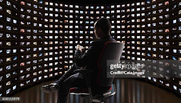 man watching video on monitors - big brother imagens e fotografias de stock