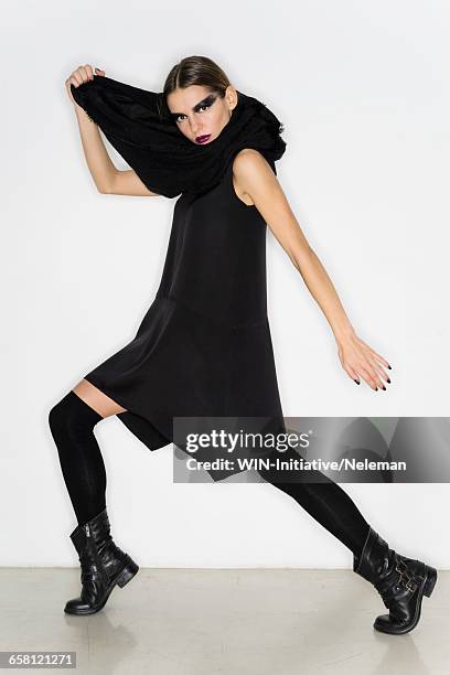 young woman in a black mini dress and scarf - black dress with stockings fotografías e imágenes de stock