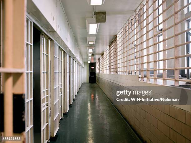 view of empty corridor in prison - prison stock-fotos und bilder