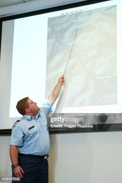 Squadron Leader Leon Fox describes locations to media during a press conference to address allegations in the book "Hit and Run" on March 27, 2017 in...