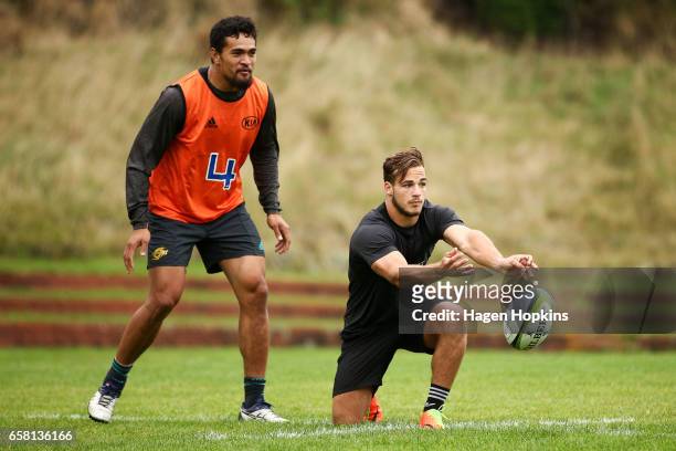 Wes Goosen passes while Vaea Fifita looks on during a Hurricanes training session at Rugby League Park on March 27, 2017 in Wellington, New Zealand.