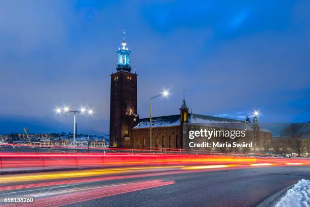 stockholm -  stockholm city hall with light trails in winter - kungsholmen town hall stockfoto's en -beelden