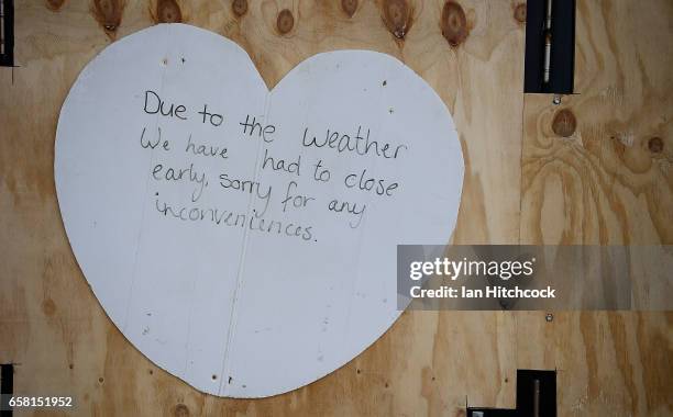 Seen is a shop closure notice at an ice cream shop on the Strand in preparation for Cyclone Debbie on March 27, 2017 in Townsville, Australia....