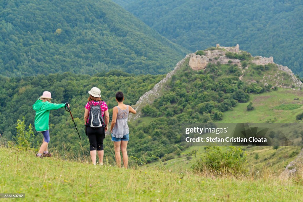 Girls hiking to Liteni fortress Transylvania