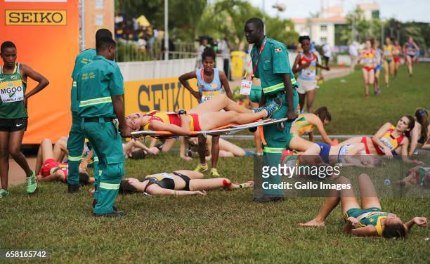 Exhausted athletes at the finish line during the U20 women race of the 2017 Kampala IAAF World Cross Country Championships on March 26, 2017 in...