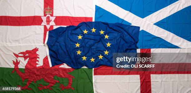 Picture shows flags arranged as an illustration, a European Union flag placed on top of an Ulster Banner , a Scottish Saltire , The Red Dragon, the...