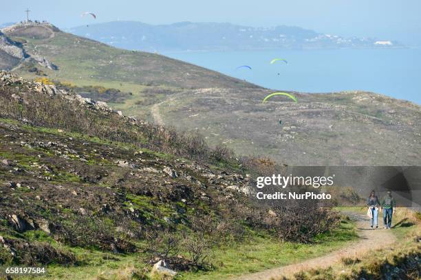 General view of a part of Bray-Greystones cliff walk with a view of Bray Head in the background and people enjoying Paragliding. On Sunday, March 26...