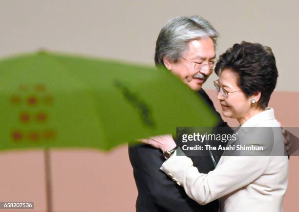 Carrie Lam , Hong Kong's chief executive-elect and candidate and former financial secretary John Tsang hug following the results announcement of the...