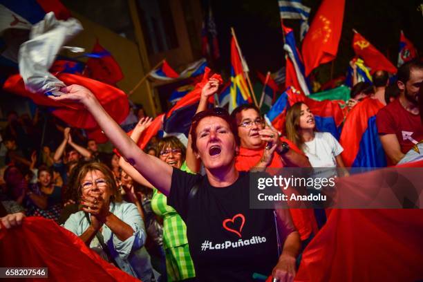 Woman sings as others hold flags during the 46th anniversary celebrations of the establishment of the Frente Amplio in Las Piedras, Canelones on...