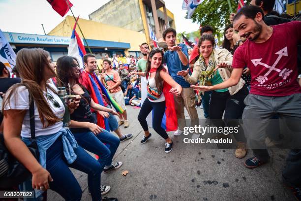 People dance in the streets during the 46th anniversary celebrations of the establishment of the Frente Amplio in Las Piedras, Canelones on March 26,...