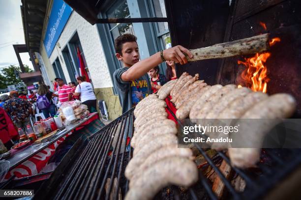 Street vendor cooks the typical "chorizo al pan" , during the 46th anniversary celebrations of the establishment of the Frente Amplio in Las Piedras,...