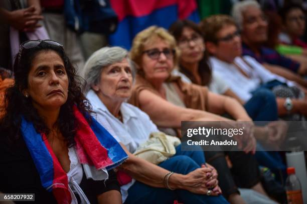 Women participators sit in the streets during the 46th anniversary celebrations of the establishment of the Frente Amplio in Las Piedras, Canelones...