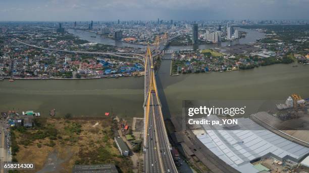 bhumibol bridge over chao phraya river against sky - river chao phraya stock pictures, royalty-free photos & images