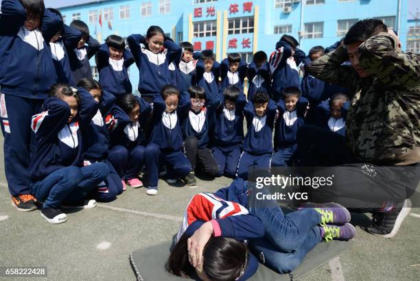 Teacher teaches students to protect themselves in a stampede at Hanshan Nagisa River Road Primary School on March 27, 2017 in Handan, Hebei Province...