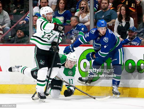 Dan Hamhuis of the Dallas Stars looks on as Michael Chaput of the Vancouver Canucks checks Devin Shore of the Dallas Stars during their NHL game at...