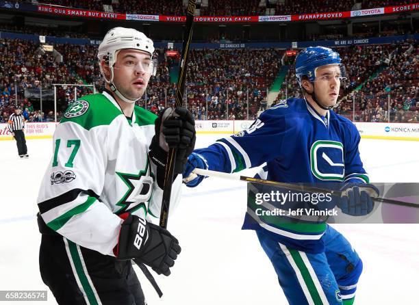 Nikita Tryamkin of the Vancouver Canucks checks Devin Shore of the Dallas Stars during their NHL game at Rogers Arena March 16, 2017 in Vancouver,...