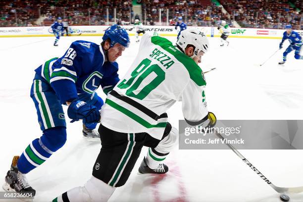 Nikita Tryamkin of the Vancouver Canucks checks Jason Spezza of the Dallas Stars during their NHL game at Rogers Arena March 16, 2017 in Vancouver,...