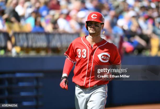 Jesse Winker of the Cincinnati Reds rounds the bases after hitting a home run against the Chicago Cubs in the second inning of their exhibition game...