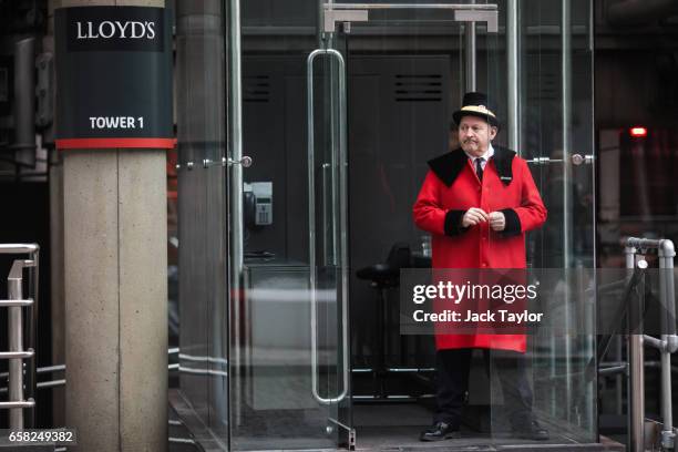 Doorman stands outside the Lloyd's building, home of the world's largest insurance market Lloyd's of London, on March 27, 2017 in London, England....