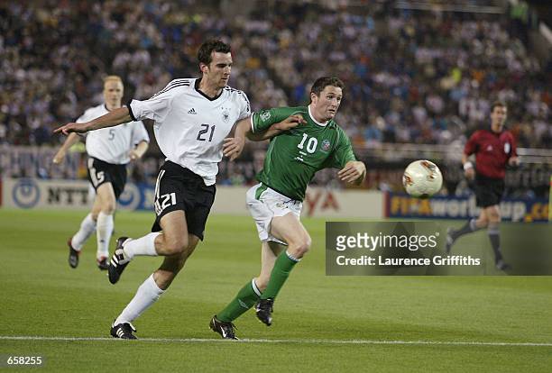 Robbie Keane of Republic of Ireland and Christoph Metzelder of Germany battle for the ball during the Group E match of the World Cup Group Stage...