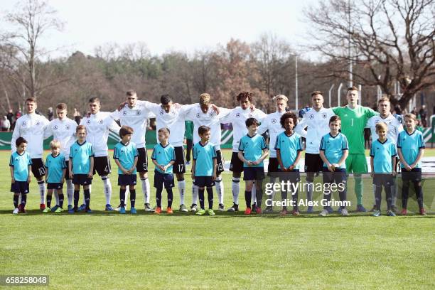 Players of Germany stand together during their national anthem prior to the UEFA Elite Round match between U19 Germany and U19 Serbia at Sportpark on...