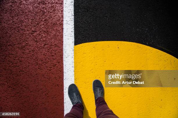original composition with vivid colors taken from personal perspective with feet and legs on the street. - different perspective stock-fotos und bilder