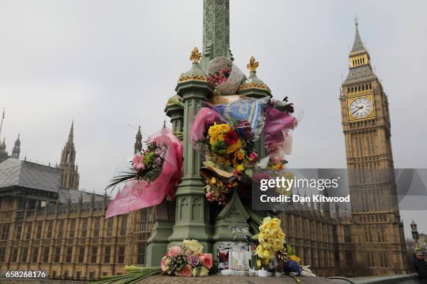 Flowers are left on Westminster Bridge by the Houses of Parliament in memory of those who died in last weeks Westminster terror attack on March 27,...