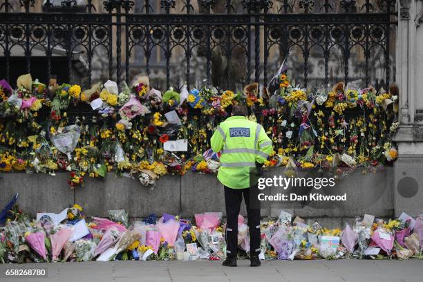 Flowers are left outside the Houses of Parliament in memory of those who died in last weeks Westminster terror attack on March 27, 2017 in London,...