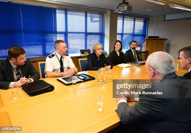 Prime Minister Theresa May talks with officers from Police Scotland about counter-terrorism issues at Govan Police Station on March 27, 2017 in...