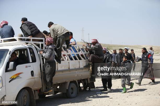 Displaced Iraqis, who fled their homes in the Old City in western Mosul due to the ongoing fighting between government forces and Islamic State group...