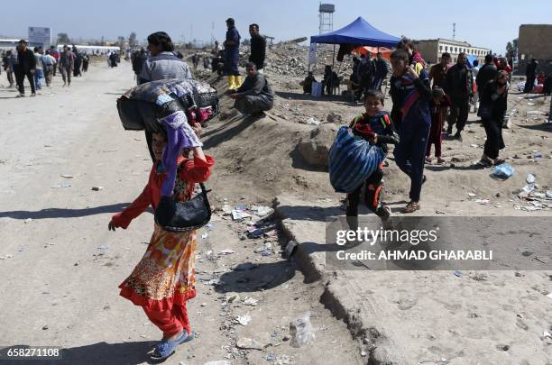 Displaced Iraqis, who fled their homes in the Old City in western Mosul due to the ongoing fighting between government forces and Islamic State group...