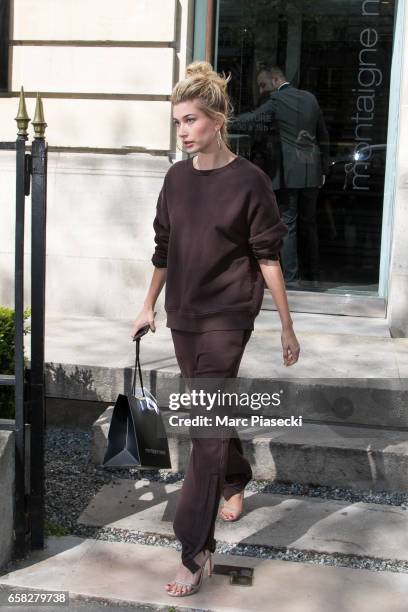 Model Hailey Baldwin leaves the 'Montaigne Market' store on Avenue Montaigne on March 27, 2017 in Paris, France.