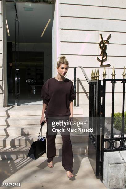 Model Hailey Baldwin leaves the 'Yves Saint Laurent' store on Avenue Montaigne on March 27, 2017 in Paris, France.