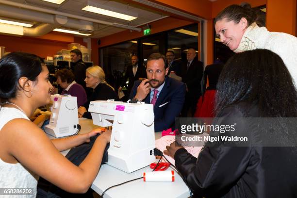 Crown Prince Haakon of Norway speaks to woment making clothes on a sewing machine during a visit to Culture Centre in the Bjerke District on March...