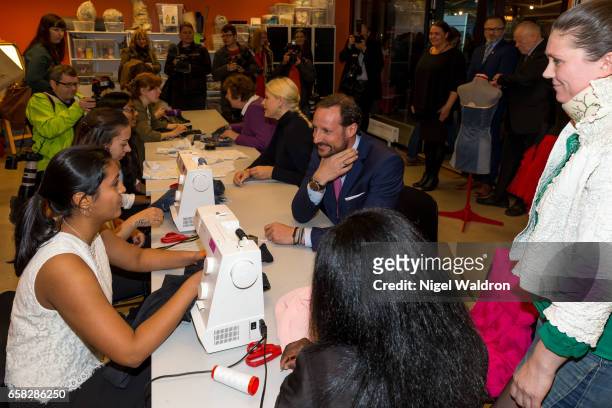 Crown Prince Haakon of Norway speaks to woment making clothes on a sewing machine during a visit to Culture Centre in the Bjerke District on March...