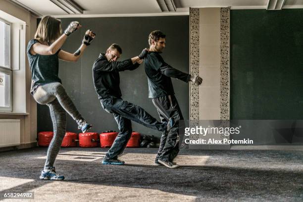 strong women practicing self-defense martial art krav maga - krav maga stock pictures, royalty-free photos & images