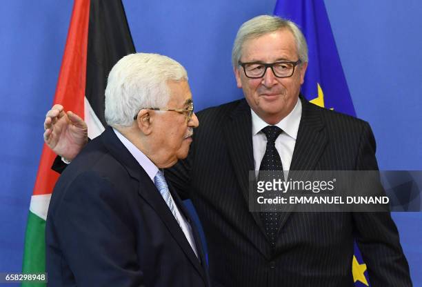 Palestinian President Mahmoud Abbas is welcomed by European Commission President Jean-Claude Juncker at the European Commission in Brussels on March...